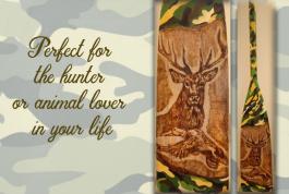 a deer and a duck wood burned onto a paddle